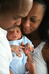 Troy and Kara Adams, Cade Foundation Family Building Grant recipients, with their son after years of infertility.